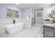 Luxurious bathroom with a freestanding tub, walk-in shower, and marble floors at 1938 Grace Ln, Charlotte, NC 28262