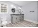 Modern bathroom with double vanity, granite countertop, and gray cabinets at 1938 Grace Ln, Charlotte, NC 28262