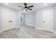 Light-filled bedroom with ceiling fan, double doors, and wood-look flooring at 1938 Grace Ln, Charlotte, NC 28262