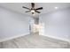 Well-lit bedroom with wood-look floors and access to another room at 1938 Grace Ln, Charlotte, NC 28262