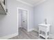 Laundry Room with gray cabinets, white sink and door to additional rooms at 1938 Grace Ln, Charlotte, NC 28262