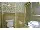 Bathroom with olive green tiled walls and a shower at 194 Bynum Rd, Lincolnton, NC 28092