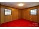 Bedroom with wood paneled walls and red carpet at 194 Bynum Rd, Lincolnton, NC 28092