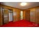 Spacious bedroom with wood paneling and red carpet at 194 Bynum Rd, Lincolnton, NC 28092