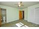 Bedroom with light green walls, ceiling fan and adjacent bathroom at 194 Bynum Rd, Lincolnton, NC 28092