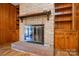 Brick fireplace with wood mantel and built-in shelving at 194 Bynum Rd, Lincolnton, NC 28092