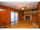 Living room with brick fireplace, built-in shelving, and slider to deck at 194 Bynum Rd, Lincolnton, NC 28092