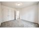 Bright bedroom with double doors to a hallway and grey carpet at 205 Benfield Rd, Kings Mountain, NC 28086