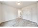 Bright bedroom with neutral carpeting and double doors leading to a bathroom at 205 Benfield Rd, Kings Mountain, NC 28086