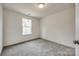 Well-lit bedroom with grey carpet and a window at 207 Benfield Rd, Kings Mountain, NC 28086