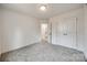 Bright bedroom featuring grey carpet and double doors to closet at 207 Benfield Rd, Kings Mountain, NC 28086