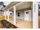 Covered front porch with white columns and a white door at 207 Benfield Rd, Kings Mountain, NC 28086