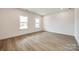 Light-filled living room with hardwood floors and two windows at 207 Benfield Rd, Kings Mountain, NC 28086