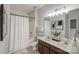 Bright bathroom features double sink vanity with framed mirror and shower with tub at 2151 Belle Vernon Ave, Charlotte, NC 28210