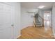 Bright entryway with hardwood floors and staircase leading upstairs at 2151 Belle Vernon Ave, Charlotte, NC 28210