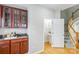 Kitchenette featuring wooden cabinets, granite countertop, and access to a powder room at 2151 Belle Vernon Ave, Charlotte, NC 28210