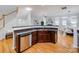 Open concept kitchen with stainless steel dishwasher and wooden cabinets at 2151 Belle Vernon Ave, Charlotte, NC 28210