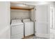 Convenient laundry closet equipped with washer, dryer, and storage shelving at 2151 Belle Vernon Ave, Charlotte, NC 28210