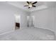 Main bedroom with grey carpet, ceiling fan, and ensuite bathroom at 2151 Belle Vernon Ave, Charlotte, NC 28210