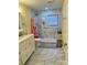 Bathroom featuring marble tiles, a shower, modern fixtures, and ample counter space at 217 Ruby Ln, Gastonia, NC 28054