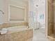 Clean bathroom with a shower and a large soaking tub at 2823 Providence Rd # 252, Charlotte, NC 28211