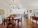 Spacious dining room with hardwood floors and a chandelier at 2823 Providence Rd # 252, Charlotte, NC 28211