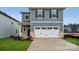 Two-story house with gray siding, white garage door, and landscaping at 307 Bezelle Ave, York, SC 29745