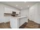 Modern kitchen featuring white cabinets, quartz countertops, and an island at 307 Bezelle Ave, York, SC 29745