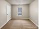 Simple bedroom with carpet flooring and a window with blinds at 3164 River Rd, Lincolnton, NC 28092