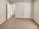 Bedroom with neutral wall and carpet flooring, and two doors at 3164 River Rd, Lincolnton, NC 28092