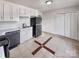 Kitchen features white cabinets, black appliances, and tile flooring at 3164 River Rd, Lincolnton, NC 28092