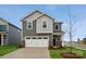 Two-story house with gray siding, white garage door, and landscaped lawn at 319 Bezelle Ave, York, SC 29745