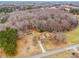 An aerial view of the home and property nestled amongst the trees on an expansive parcel of land at 33287 Mann Rd, Albemarle, NC 28001