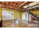 Unfinished basement with exposed ceiling, shelves and stairs at 33287 Mann Rd, Albemarle, NC 28001