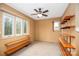 Bedroom with neutral carpet, built in shelves, two windows providing natural light, and neutral paint at 33287 Mann Rd, Albemarle, NC 28001