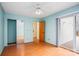 Bedroom featuring laminate floors, sliding closet doors, backyard access, and neutral paint at 33287 Mann Rd, Albemarle, NC 28001