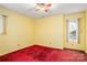 Bright bedroom with a ceiling fan and natural light from the window at 33287 Mann Rd, Albemarle, NC 28001