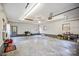 Spacious garage featuring a white door, fluorescent lighting and a window at 33287 Mann Rd, Albemarle, NC 28001