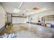 Spacious garage featuring a white door, fluorescent lighting and a window at 33287 Mann Rd, Albemarle, NC 28001