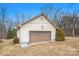 Garage exterior featuring a brown garage door and some shrubbery at 33287 Mann Rd, Albemarle, NC 28001