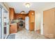 Cozy kitchen with stainless steel appliances, wood cabinets, a pantry, and a sliding door at 33287 Mann Rd, Albemarle, NC 28001