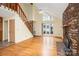 Inviting living room boasts hardwood floors, a stone fireplace, and abundant natural light from large windows at 33287 Mann Rd, Albemarle, NC 28001