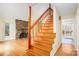 Staircase leading to living area featuring stone fireplace, high ceilings, and lots of natural light at 33287 Mann Rd, Albemarle, NC 28001