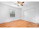 Hardwood floor bedroom with ceiling fan and closet at 3515 Back Creek Church Rd, Charlotte, NC 28213