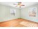 Light-filled bedroom featuring hardwood floors and wainscoting at 3515 Back Creek Church Rd, Charlotte, NC 28213