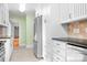 Kitchen with stainless steel appliances, white cabinets and view to dining area at 3515 Back Creek Church Rd, Charlotte, NC 28213