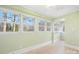 Sunroom with light walls, tile floors, and multiple windows at 3515 Back Creek Church Rd, Charlotte, NC 28213