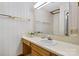 Bathroom features a vanity with wood cabinets, a sink, and neutral-toned wallpaper at 3910 6Th Nw St, Hickory, NC 28601