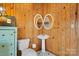 Charming bathroom with pedestal sink, toilet and wood walls at 3910 6Th Nw St, Hickory, NC 28601