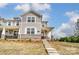 Two-story townhome with gray siding, stone accents, and a covered porch at 4000 Cheyney Park Dr, Charlotte, NC 28269